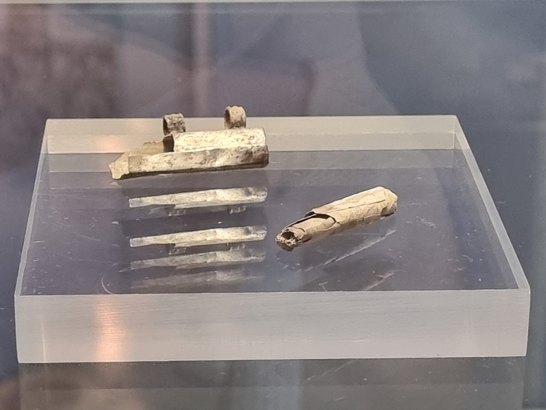 The Frankfurt silver amulet capsule and its rolled foil.