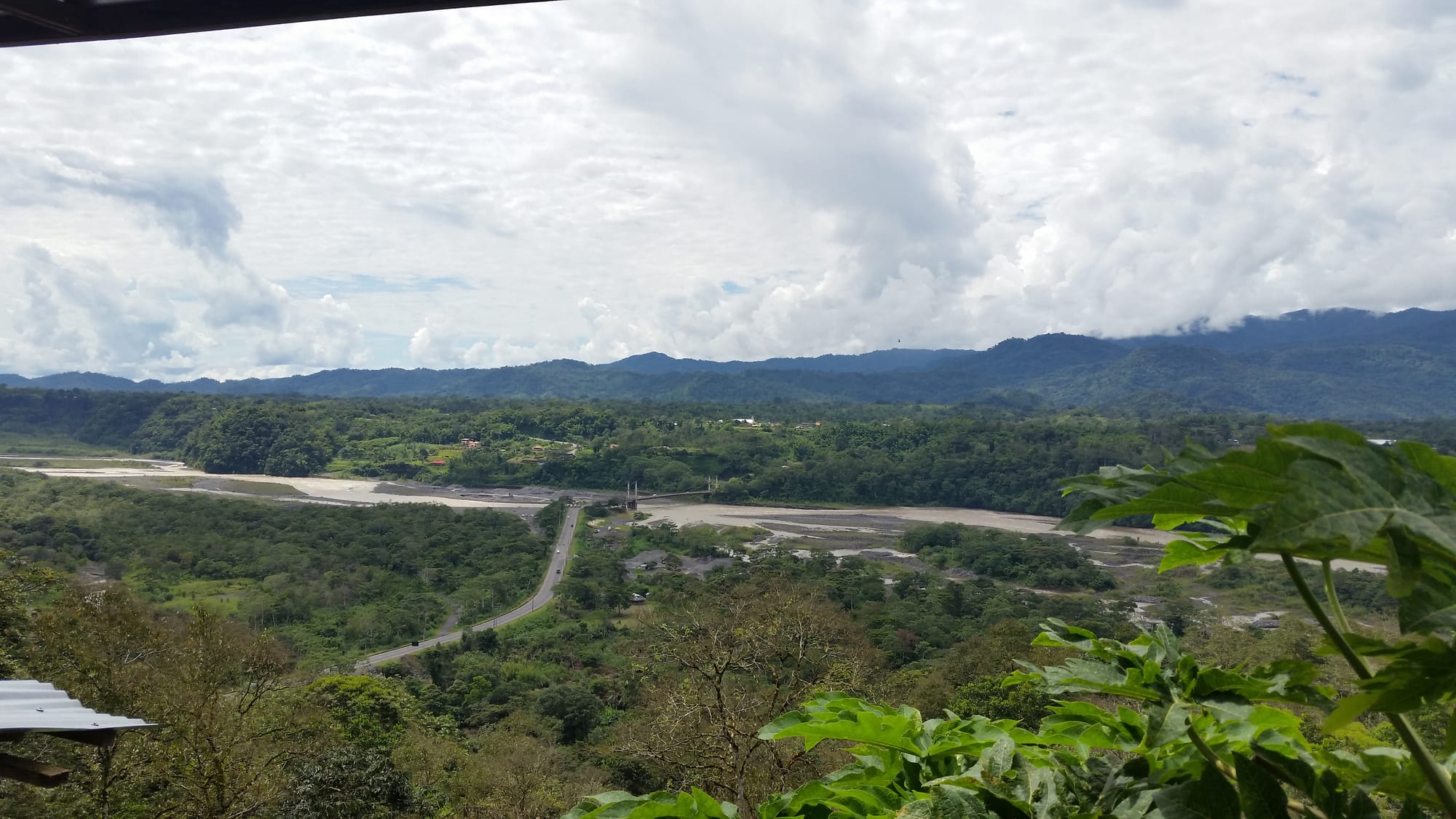 an aerial or landscape view of the Upano River valley in Morona-Santiago Province, eastern Ecuador, showing the river and surrounding forest